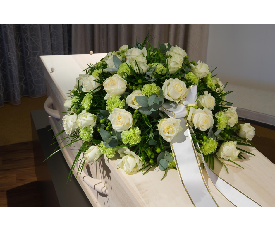 white casket with a white bouquet | funeral planning faq | overnight caskets