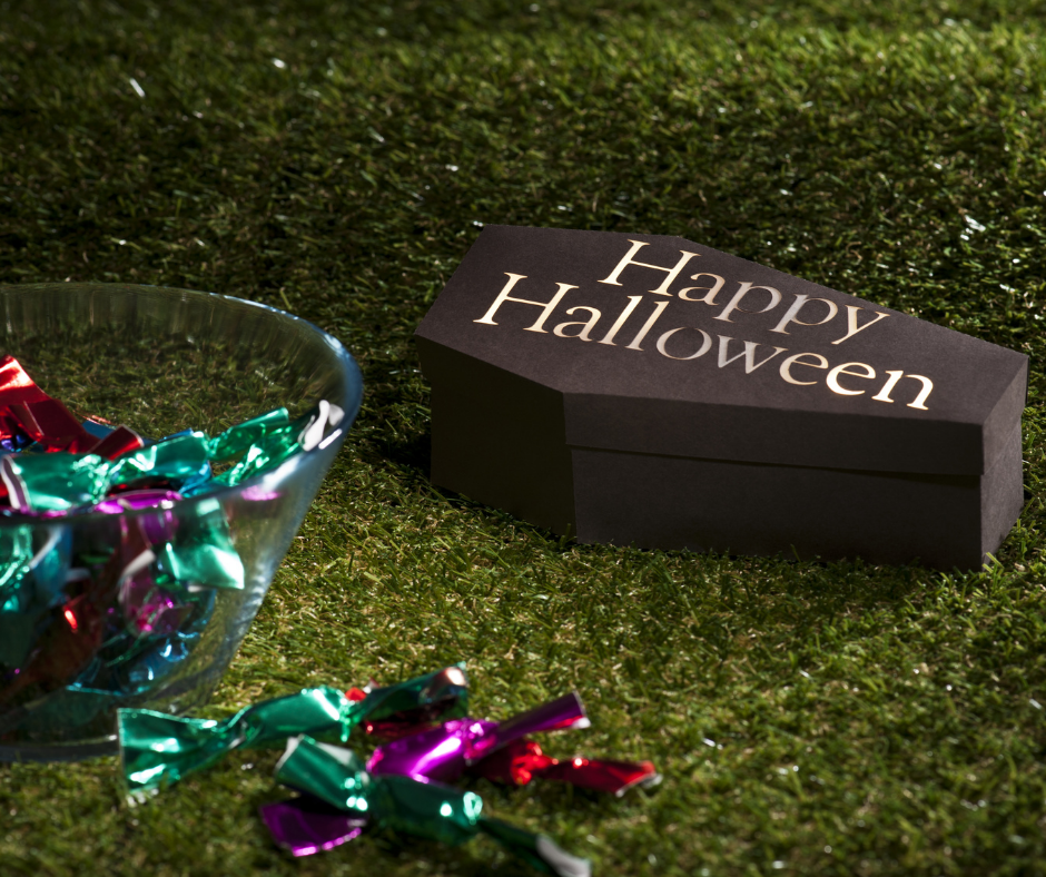 toy coffin that says "happy halloween" with a bowl of candy | Coffin vs. Casket | Overnight Caskets 