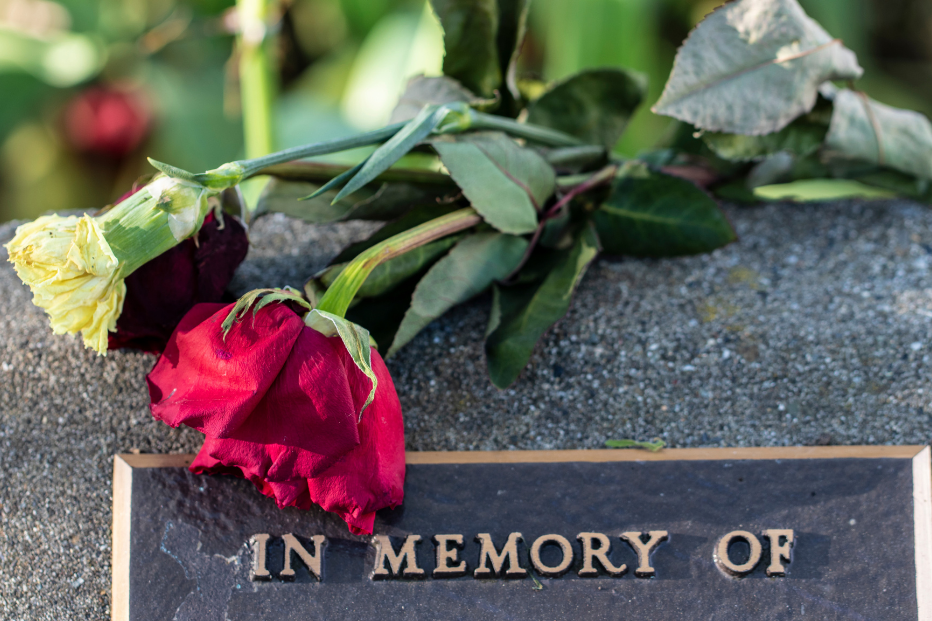 red rose on gravestone | Burial vs. Cremation | Overnight Caskets