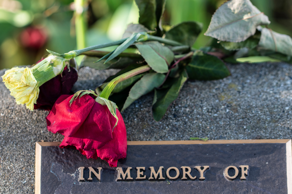 uniform headstones under a blossoming tree | Buy a burial vault online | Overnight Caskets