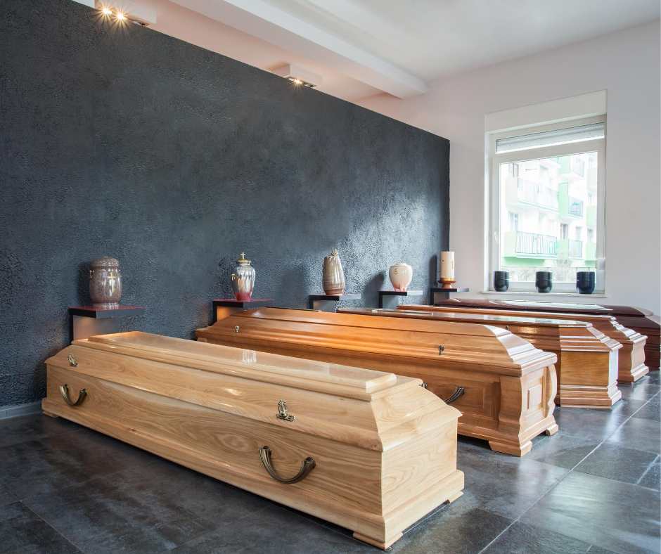 row of wood caskets in display room | Pre-purchase a casket with Overnight Caskets